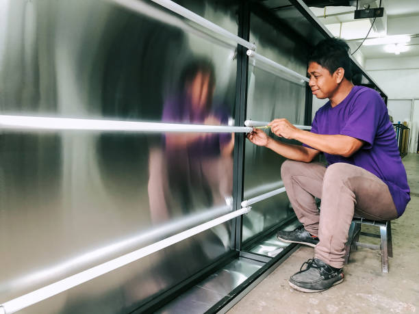 Wide angle of worker sitting down working with hand holding test pen